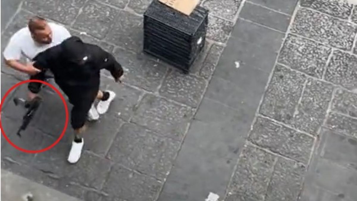 Masked man with a firearm roams Naples.