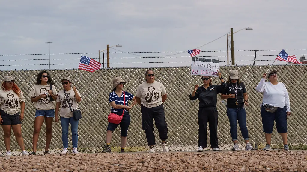 FILE-PHOTO-Protesters-opposing-mass-deportations-by-ICE-hold-signs-during-a-protest-held-at-the-Cassidy-Gate-at-Fort-Bliss-the-U-S-Army-base-where-a-large-new-ICE-detention-facility-is-being-built-in-El-Paso-Texas-U-S-August-17-2025