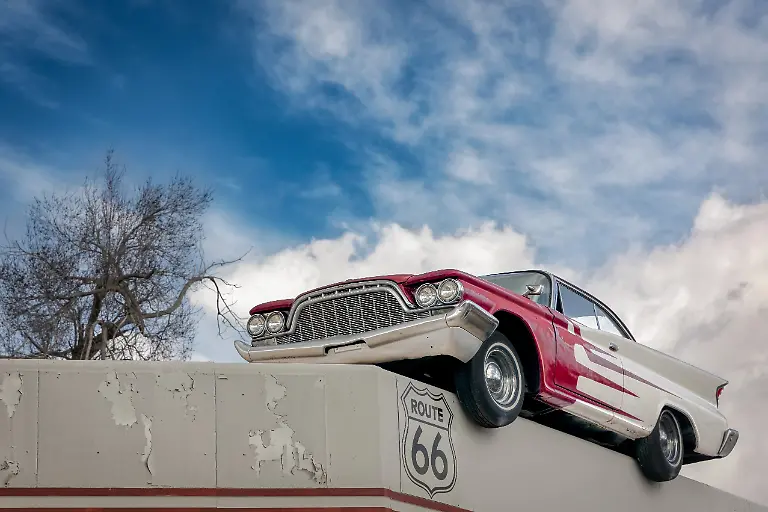 An-old-classic-car-sits-on-the-roof-of-a-building-on-historic-Route-66-at-Ash-Fork-Arizona