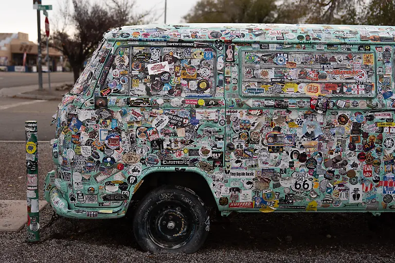 A-vehicle-covered-in-stickers-is-parked-outside-a-souvenir-shop-in-Seligman-Ariz-a-town-on-historic-Route-66-Friday-Nov-21-2025-AP-Photo-Jae-C