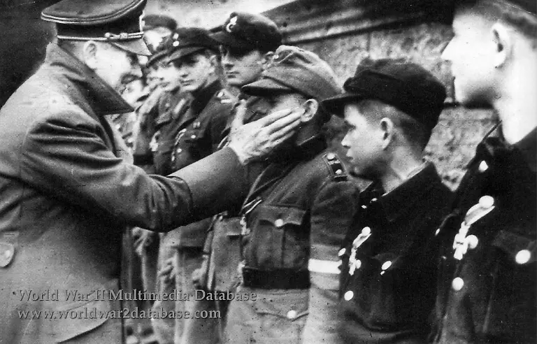 Adolf-Hitler-touches-the-face-of-Wilhelm-Willi-Hubner-1929-April-12-2010-the-youngest-recipient-of-the-Iron-Cross