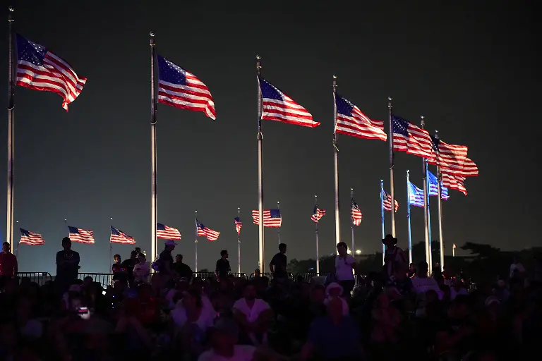 People-gather-at-the-Washington-Monument-as-U-S-flags-fly-to-watch-the-fireworks-during-the-Freedom-250-s-Salute-to-America-as-the-United-States-celebrates-its-250th-anniversary-on-Independence-Day-in-Washington-D-C-U-S-July-4-2026