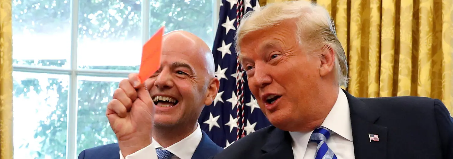 FILE-PHOTO-U-S-President-Donald-Trump-holds-up-a-red-card-as-he-meets-with-FIFA-President-Gianni-Infantino-in-the-Oval-Office-of-the-White-House-in-Washington-U-S-August-28-2018