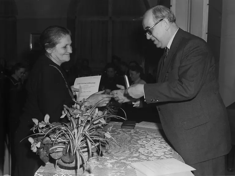 Ernst-Reuter-mayor-of-Berlin-decorates-63-year-old-rubble-woman-Chania-Tessmann-with-the-Federal-Cross-of-Merit-for-her-dedication-in-rebuilding-Berlin-here-in-Berlin-Germany-December-6-1952-Along-with-Mrs-Tessmann-28-other-rubble-women-were-honored-AP-Photo-Sanden-Jr