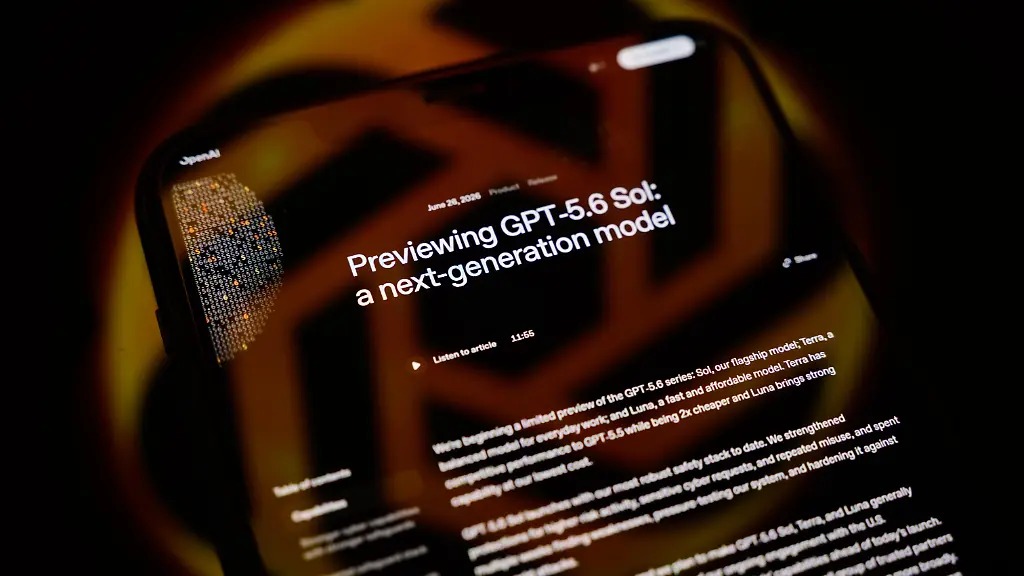 The-GPT-5-6-presentation-page-is-displayed-on-a-smartphone-screen-placed-on-a-reflective-surface-onto-which-the-company-logo-is-projected-in-Creteil-France-on-June-29-2026-OpenAI-announces-the-release-of-the-latest-update-to-its-flagship-language-model