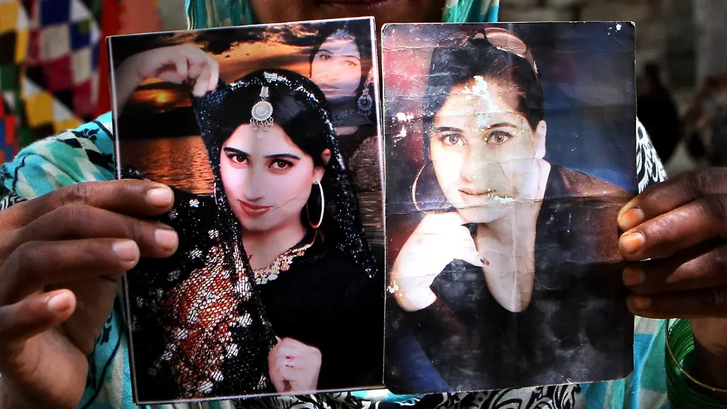 FILE-In-this-file-picture-taken-on-July-22-2016-a-family-member-shows-pictures-of-slain-fashion-model-Qandeel-Baloch-in-Shah-Sadderuddin-Pakistan-Baloch-grew-up-in-a-poor-farming-family-but-aalways-wanted-more-had-different-ideasa-her-sister-says-After-escaping-her-childhood-poverty-and-an-abusive-marriage-to-find-online-fame-she-was-killed-by-her-brother-for-refusing-to-live-a-life-dictated-by-repressive-tribal-and-religious-traditions
