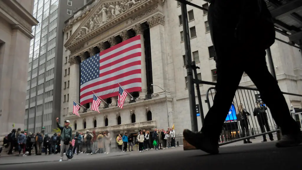 A-person-walks-past-the-New-York-Stock-Exchange-in-the-Financial-District-in-Manhattan-New-York-City