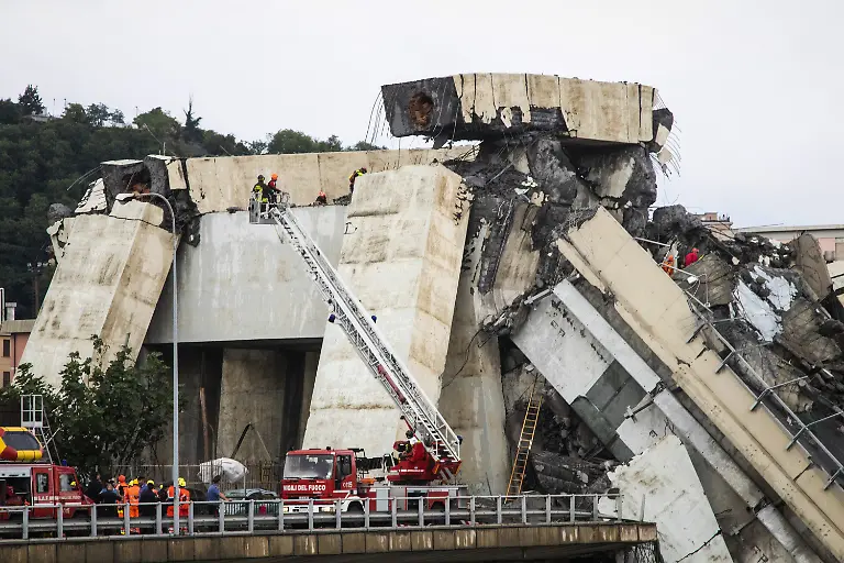 Rescue-workers-at-the-Morandi-bridge-which-collapsed-on-August-14-2018-in-Genoa-Italy-At-at-least-22-people-have-died-when-a-large-section-of-Morandi-bridge-built-in-the-1960s-and-part-of-the-A10-motorway-suddenly-collapsed-during-a-fierce-storm-sending-vehicles-falling-up-to-90m-to-the-ground