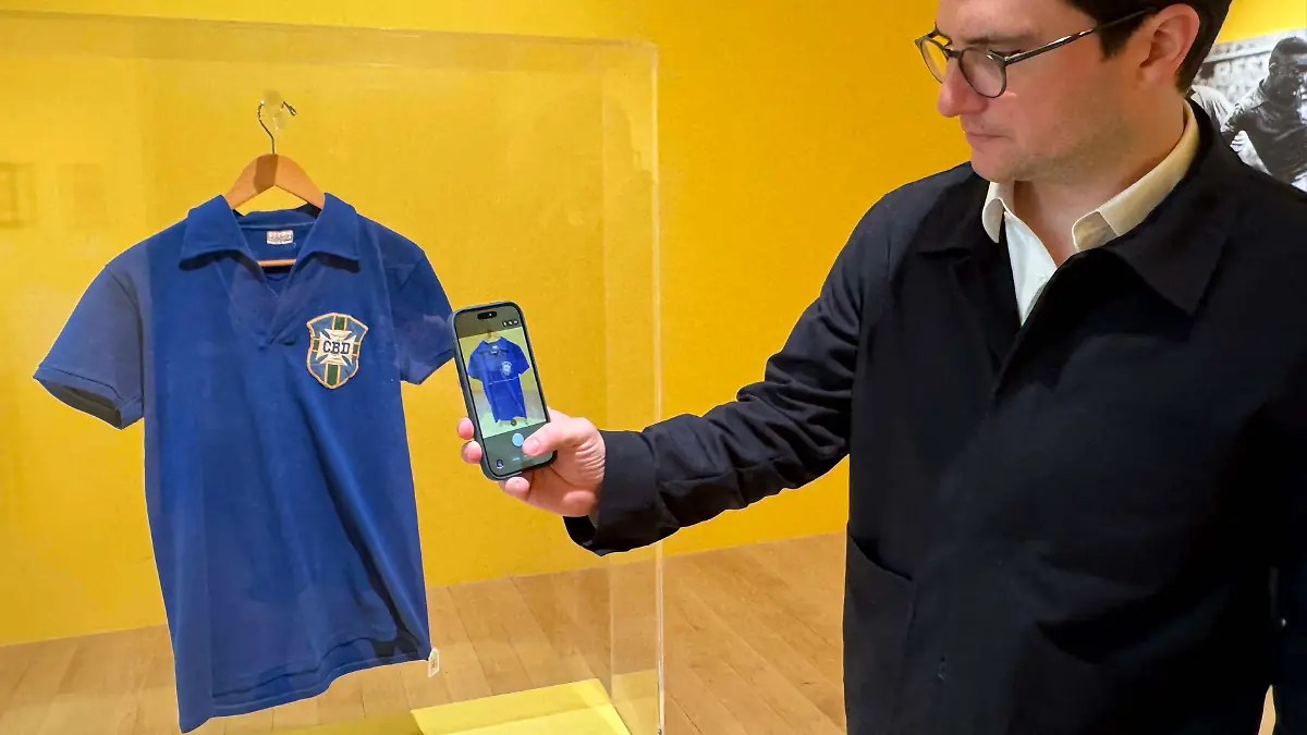 July-1-2026-New-York-New-York-USA-BRENDAN-HAWKES-VP-Sports-Strategy-and-Development-takes-a-cellphone-photo-of-the-Pele-1958-FIFA-World-Cup-Final-Championship-Clinching-Match-Worn-Shirt-estimate-over-1-million-seen-during-The-Beautiful-Game-Sports-Week-Auction-at-Sotheby-s-New-York-Presents-The-Summer-Season-at-the-Breuer