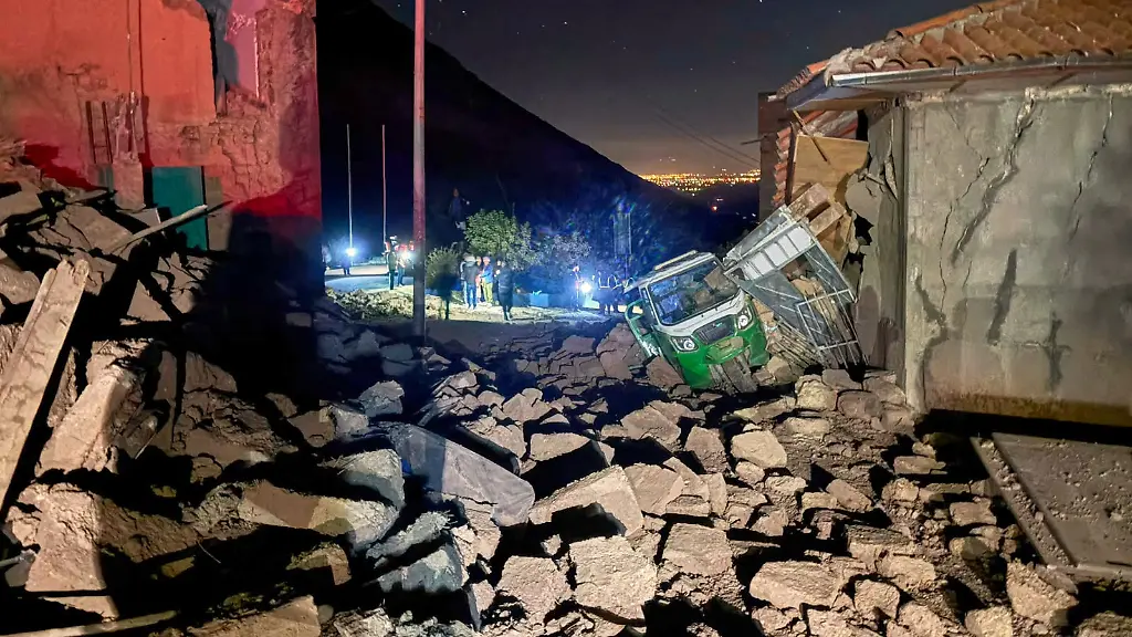 A-motor-tricycle-is-stuck-amid-the-debris-of-homes-that-collapsed-after-an-earthquake-struck-Pumpuya-Peru-Sunday-July-19-2026