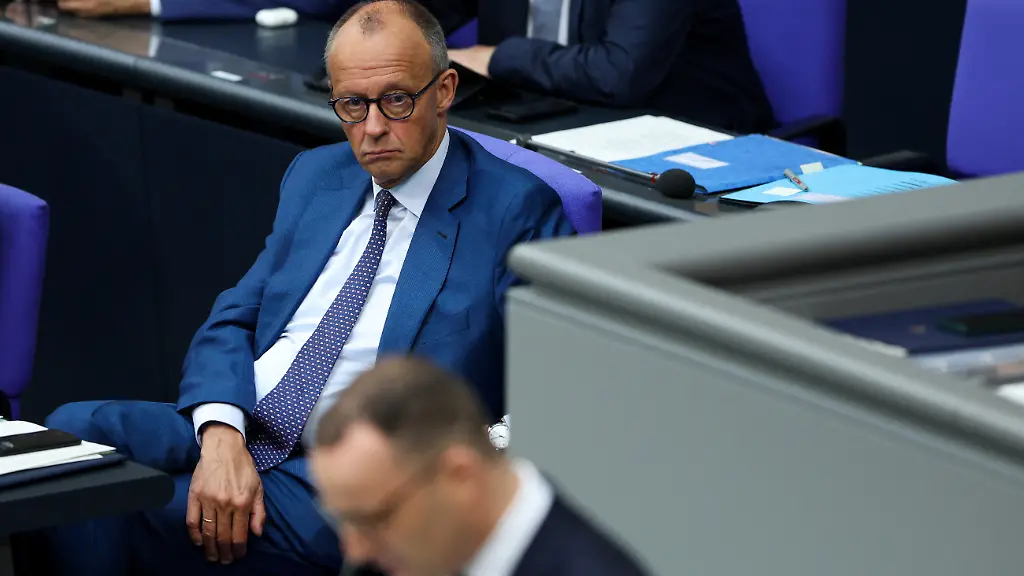 German-Chancellor-Friedrich-Merz-looks-on-as-Head-of-the-CDU-CSU-parliamentary-group-Jens-Spahn-speaks-during-a-plenum-session-of-the-lower-house-of-parliament-the-Bundestag-in-Berlin-Germany-July-9-2026