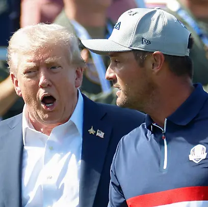 President-Donald-Trump-L-talks-with-Bryson-DeChambeau-of-Team-United-States-as-the-U-S-team-walks-to-the-first-tee-box-for-a-four-ball-match-against-Team-Europe-on-day-one-of-the-45th-Ryder-Cup-at-the-Bethpage-Black-Course-in-Farmingdale-New-York-on-Friday-September-26-2025