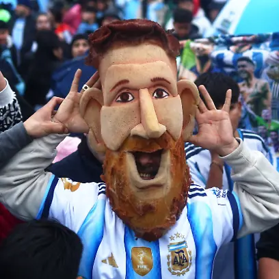 Soccer-Football-FIFA-World-Cup-2026-Argentina-players-arrive-in-Buenos-Aires-after-the-final-Buenos-Aires-Argentina-July-20-2026-Argentina-fan-wearing-a-Lionel-Messi-mask-gestures-as-supporters-gather-outside-the-Argentine-Football-Association-AFA-headquarters-on-the-outskirts-of-Buenos-Aires-after-Argentina-lost-the-World-Cup-final-to-Spain-REUTERS-Matias-Baglietto