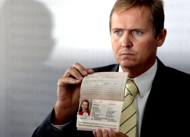 epa00800775-Generalmajor-Gerhard-Lang-of-the-Austrian-Federal-Police-holds-up-the-passport-of-Natascha-Kampusch-during-a-press-conference-in-Vienna-Thursday-24-August-2006-An-18-year-old-girl-who-miraculously-turned-up-alive-after-she-had-been-held-captive-for-eight-years-was-identified-as-the-missing-Natascha-Kampusch-on-Thursday-Police-said-a-medical-examination-showed-a-scar-on-the-same-place-on-her-body-as-Natascha-had-had-when-she-vanished-aged-10-in-March-1998-The-police-statement-came-after-a-drama-on-Wednesday-in-which-Natascha-escaped-from-a-car-driven-by-her-kidnapper-The-44-year-old-man-abandoned-the-car-and-hours-later-committed-suicide-by-throwing-himself-under-a-train