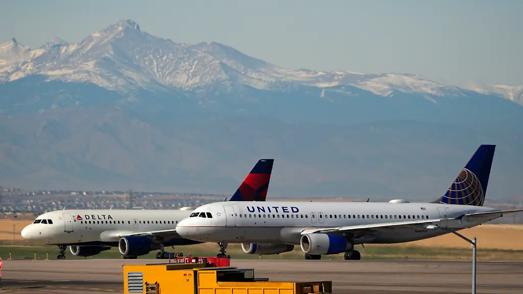 FILE-United-and-Delta-Airlines-jetliners-taxi-down-a-runway-for-take-off-at-Denver-International-Airport-Dec-24-2024-in-Denver