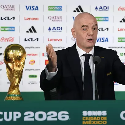 FIFA-President-Gianni-Infantino-speaks-during-a-press-conference-in-Mexico-City-on-June-10-2026-the-eve-of-the-World-Cup-opener-between-Mexico-and-South-Africa-The-winners-trophy-is-placed-in-front-of-him