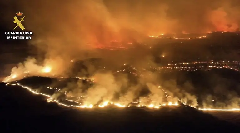 This-screen-grab-taken-from-handout-aerial-video-footage-released-on-July-18-2026-by-Spain-s-Pegaso-unit-of-the-Guardia-Civil-shows-the-military-fighting-a-massive-wildfire-in-Cinco-Villas-area-near-Zaragoza-in-a-sparsely-populated-part-of-the-Aragon-region-in-northeastern-Spain-A-major-wildfire-that-has-been-raging-for-three-days-in-northeast-Spain-has-reduced-more-than-15-400-of-land-to-ash
