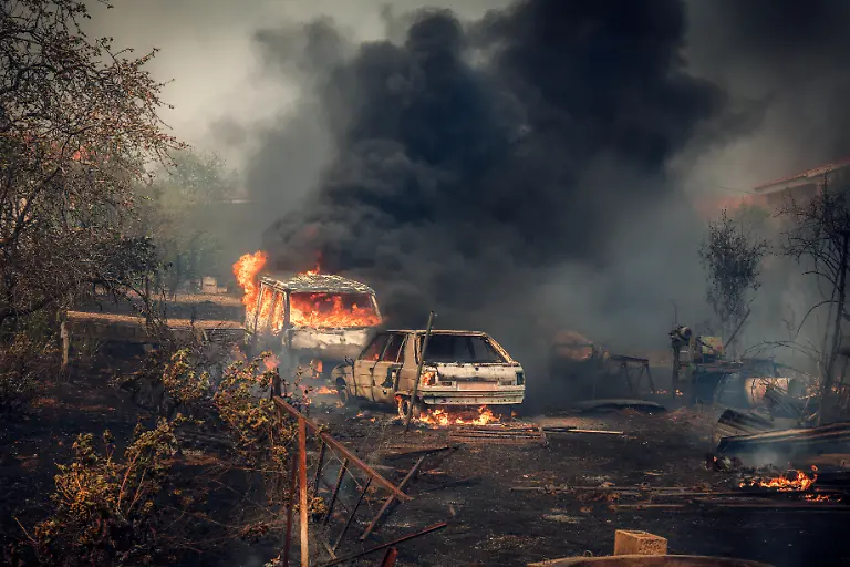 This-handout-photo-released-on-July-26-2026-and-taken-on-July-24-2026-by-Spain-s-Military-Emergencies-Unit-UME-shows-vehicles-in-flames-during-a-wildfire-near-Navas-del-Rey-55-kilometers-southwest-of-Madrid-Spain-faces-two-crucial-days-to-bring-raging-wildfires-under-control-before-weather-conditions-worsen-authorities-said-on-July-27-2026-though-they-were-making-some-progress-and-planned-to-start-returning-evacuees-to-certain-areas-The-wildfires-that-broke-out-in-forested-areas-around-the-Spanish-capital-at-the-height-of-the-summer-holidays-have-forced-some-60-000-people-to-flee-their-homes-often-with-just-minutes-notice-leaving-pets-and-medicine-behind
