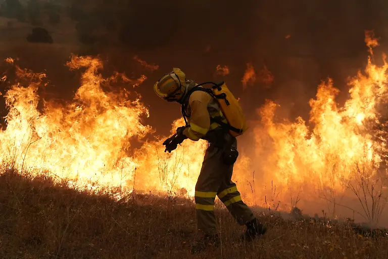 Firefighters-battle-a-wildfire-in-Cebreros-area-near-Avila-80-kms-west-of-Madrid-on-July-24-2026-Spain-declared-a-national-emergency-in-the-Madrid-region-and-in-the-province-of-Avila-near-the-capital-on-July-23-2026-in-the-wake-of-several-wildfires-burning-out-of-control-Scientists-have-long-warned-that-climatechange-caused-by-human-use-of-fossil-fuels-will-make-periods-of-drought-more-intense-and-longer-lasting-creating-the-ideal-conditions-for-wildfires