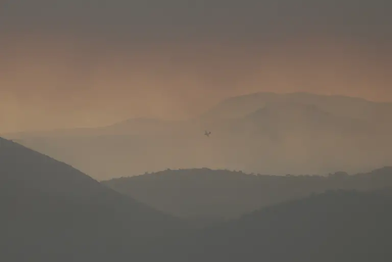 A-picture-taken-on-July-24-2026-in-Puerto-de-la-Cruz-Verde-near-Avila-80-kms-west-of-Madrid-shows-a-view-of-the-smoke-from-a-wildfire-raging-west-of-the-Spanish-capital-The-worst-wildfires-in-the-Madrid-region-s-history-rage-west-of-the-Spanish-capital-forcing-authorities-to-evacuate-or-order-around-40-000-people-to-remain-indoors