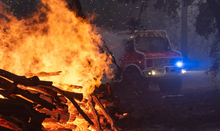This-handout-photograph-taken-on-July-24-2026-by-the-Caporal-chef-Damien-Rembert-of-the-SDIS33-Departmental-Fire-and-Rescue-Service-shows-French-firefighters-trying-to-extinguish-the-wildfire-near-Saumos-and-Sainte-Helene-northwest-of-Bordeaux-in-the-Gironde-department-An-unprecedented-wildfire-tearing-through-southwest-France-is-heading-towards-the-city-of-Bordeaux-an-official-said-on-July-24-2026-More-than-140-000-people-have-been-evacuated-and-22-000-hectares-have-been-burnt-throughout-the-night-from-July-24-to-July-25-the-flames-continued-to-ravage-the-Landes-region-and-in-particular-the-Gironde-where-the-authorities-are-now-concerned-for-Bordeaux-and-have-announced-tens-of-thousands-of-further-evacuations