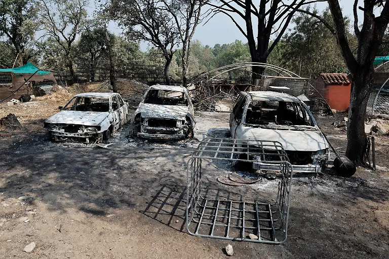 Charred-cars-are-pictured-after-a-wildfire-raged-in-La-Adrada-95-kilometres-west-of-Madrid-on-July-28-2026-Firefighters-in-Spain-made-progress-after-a-positive-night-against-wildfires-raging-west-of-Madrid-that-have-forced-the-evacuation-of-tens-of-thousands-of-people-Interior-Minister-Fernando-Grande-Marlaska-said-today-Spain-s-government-declared-a-national-emergency-last-week-over-some-of-the-worst-wildfires-in-the-country-s-history-raging-in-fronts-across-the-Madrid-region-Avila-province-Toledo-and-eastern-Valencia
