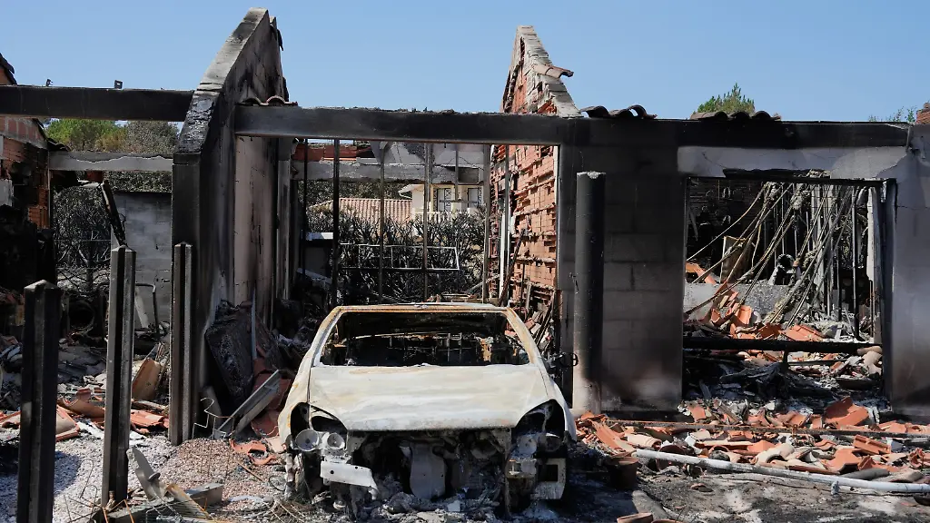 A-burned-out-automobile-and-the-remains-of-a-house-after-wildfires-raged-in-the-village-of-Le-Porge-on-the-Bay-of-Biscay-France-Monday-July-27-2026