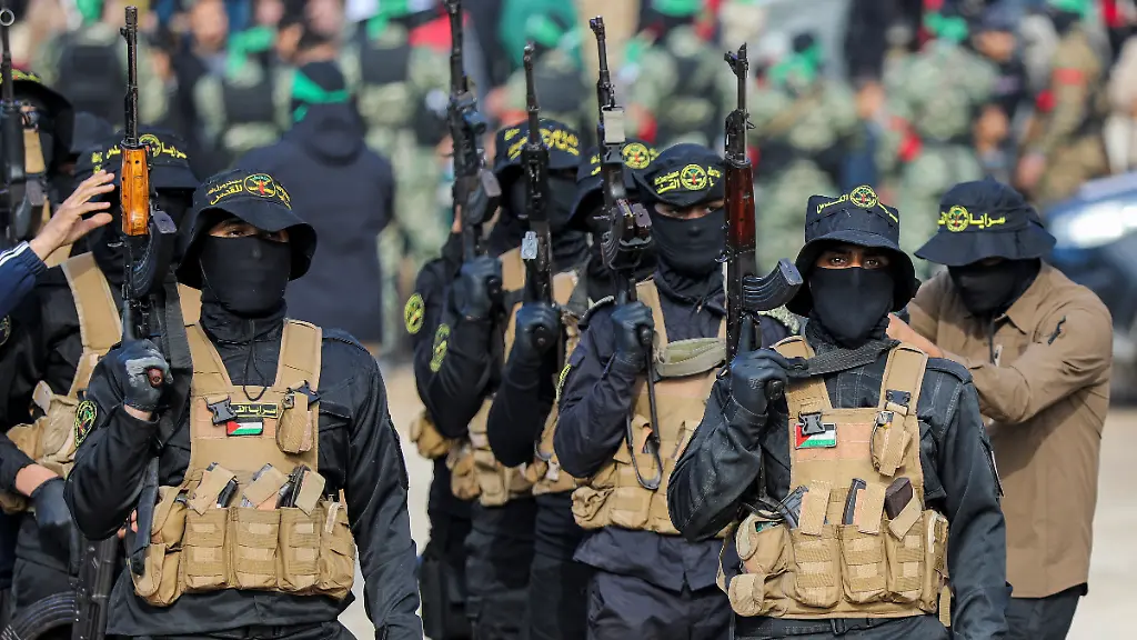 Palestinian-Islamic-Jihad-militants-stand-guard-before-the-handover-of-hostages-who-had-been-held-in-Gaza-since-the-deadly-October-7-2023-attack-to-members-of-the-International-Committee-of-the-Red-Cross-ICRC-as-part-of-a-ceasefire-and-a-hostages-prisoners-swap-deal-between-Hamas-and-Israel-in-Gaza-City-January-25-2025