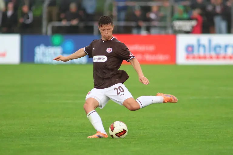 Mathias-Rasmussen-20-holt-zum-Schuss-aus-und-hat-den-Ball-vor-dem-Fuss-Im-Hintergrund-sind-Zuschauer-auf-der-Tribuene-des-Ostfriesland-Stadions-in-Emden-zu-sehen-Mathias-Rasmussen-FC-St-Pauli-beim-Schussversuch-im-Ostfriesland-Stadion-Mathias-Rasmussen-20-takes-a-shot-with-the-ball-at-his-feet-In-the-background-spectators-can-be-seen-in-the-stands-at-the-Ostfriesland-Stadium-in-Emden-Mathias-Rasmussen-of-FC-St-Pauli-attempts-a-shot-at-the-Ostfriesland-Stadium