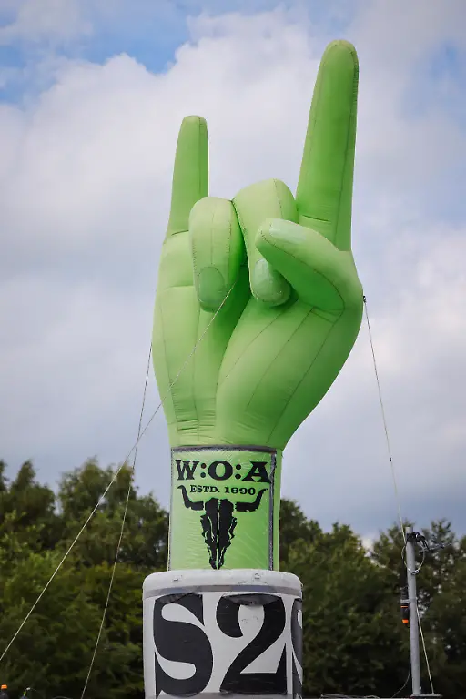 Die-Pommesgabel-das-Handzeichen-der-Metal-Fans-steht-als-aufgeblasene-Figur-auf-dem-Festivalgelaende-beim-Wacken-Open-Air-W-O-A-Das-W-O-A-gilt-als-groesstes-Heavy-Metal-Festival-der-Welt