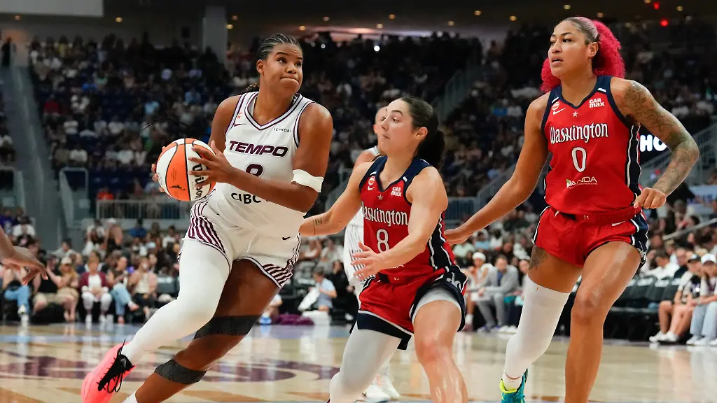 Toronto-Tempo-s-Nyara-Sabally-left-drives-at-Washington-Mystics-Georgia-Amoore-8-and-Shakira-Austin-0-during-the-first-half-of-a-WNBA-basketball-game-in-Toronto-Tuesday-July-14-2026