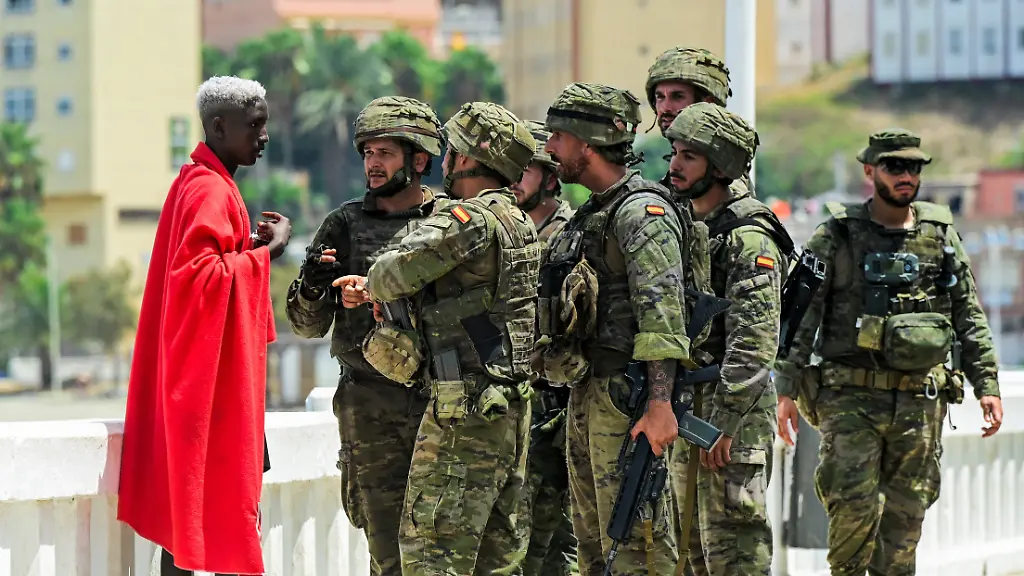 Spanish-soldiers-question-a-migrant-following-mass-crossings-of-migrants-on-foot-and-by-sea-from-Morocco-into-Spanish-territory-in-Ceuta-Spain-August-1-2026