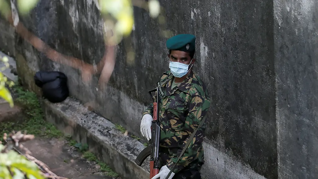 A-Special-Task-Force-soldier-stands-guard-near-the-boundary-wall-of-Mahara-Prison-following-unrest-inside-the-prison-on-the-outskirts-of-Colombo-Sri-lanka-November-30-2020