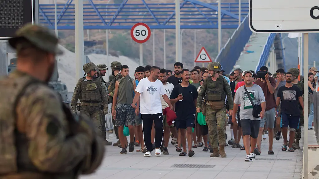 Escorted-by-the-Spanish-army-migrants-who-crossed-into-Spain-return-to-Morocco-from-the-Spanish-enclave-of-Ceuta-on-Saturday-Aug-1-2026