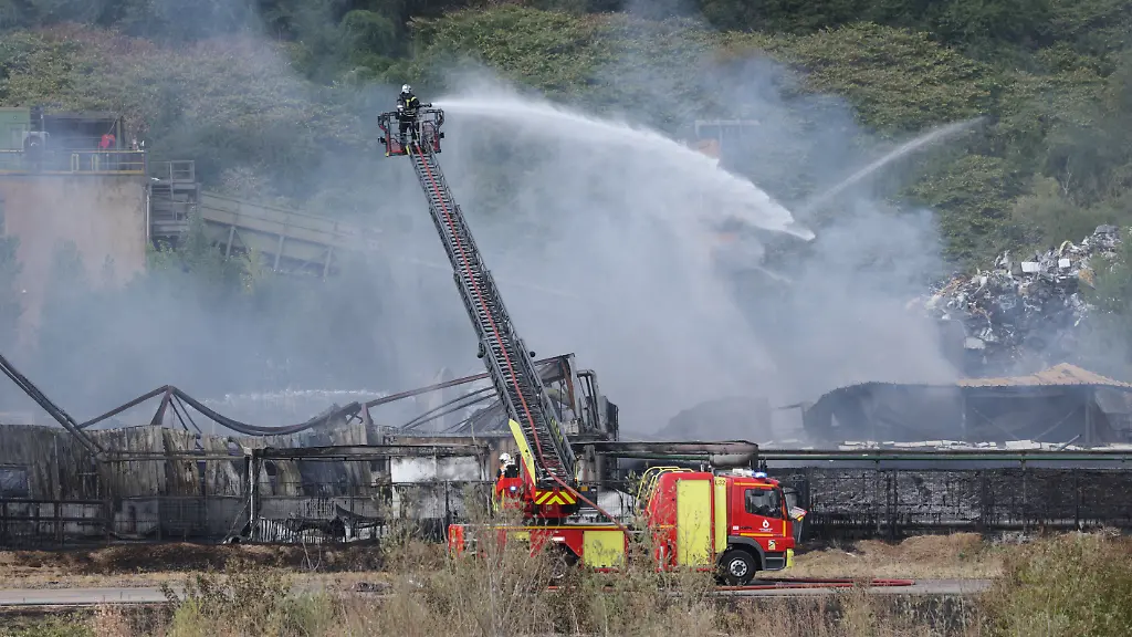 French-firefighters-spray-water-with-a-truck-at-a-fire-of-a-500-square-meter-warehouse-at-the-Safe-company-site-in-the-Gandrange-industrial-zone-in-the-Moselle-department-northeastern-France-on-August-2-2026-The-Moselle-prefecture-ordered-residents-of-Amneville-and-four-neighboring-municipalitiestotaling-30-000-peopleto-shelter-in-place-due-to-a-fire-at-a-warehouse-classified-as-a-low-threshold-Seveso-site-As-a-precautionary-measure-residents-of-Gandrange-Amneville-Vitry-sur-Orne-Clouange-and-Rombas-are-asked-to-shelter-in-place-until-further-notice-the-prefecture-stated-in-a-press-release-The-fire-involves-a-500-square-meter-warehouse-at-the-Safe-company-site-in-the-Gandrange-industrial-zone