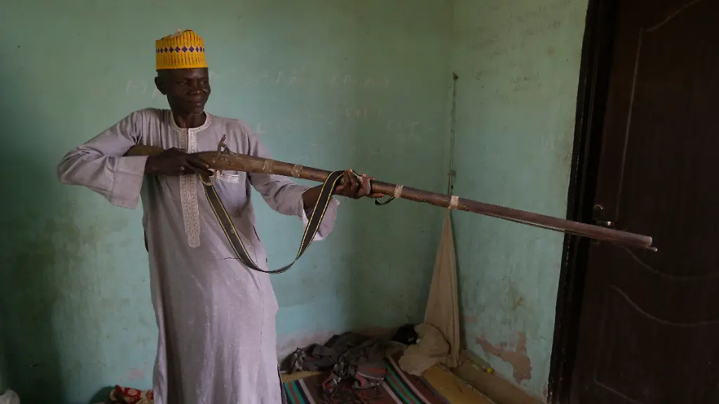 Lawani-Adali-the-security-man-on-duty-the-day-with-his-Dane-gun-explains-his-experience-on-the-day-when-more-than-300-girls-were-abducted-by-gunmen-from-the-Government-Girls-Secondary-School-in-Jangebe-town-Zamfara-state-northern-Nigeria-Monday-March-1-2021-Adali-said-policemen-and-vigilantes-couldn-t-get-in-because-the-gunmen-blocked-everywhere-there-was-heavy-firing-as-they-were-shouting-Allahu-akbar-or-God-is-great-Their-families-waited-anxiously-on-Monday-for-news-of-their-abducted-daughters-the-latest-in-a-series-of-mass-kidnappings-of-school-students-in-the-West-African-nation