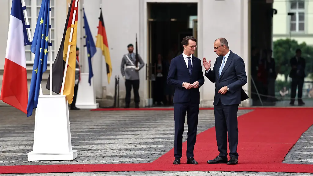 Hendrik-Wuest-M-CDU-Ministerpraesident-von-Nordrhein-Westfalen-begruesst-Bundeskanzler-Friedrich-Merz-r-CDU-vor-einem-Treffen-des-Deutsch-Franzoesischen-Ministerrats-im-Rahmen-von-Regierungskonsultationen-beider-Laender-auf-Schloss-Augustusburg