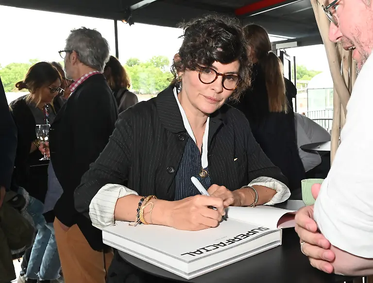 PARIS-FRANCE-JUNE-04-Actress-Audrey-Tautou-signs-her-book-during-the-Superfacial-Audrey-Tautou-s-Exhibition-Preview-at-Quai-du-Port-on-June-04-2025-in-Paris-France