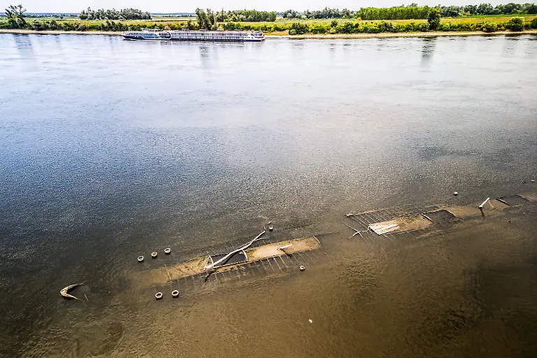 Low-water-reveals-remains-of-century-old-ship-on-Croatia-s-Danube-An-aerial-view-shows-the-remains-of-a-ship-believed-to-be-more-than-a-century-old-after-record-low-water-levels-in-the-Danube-River-exposed-the-wreck-in-Opatovac-Croatia-on-July-21-2026-The-vessel-is-believed-to-have-sunk-between-the-two-World-Wars
