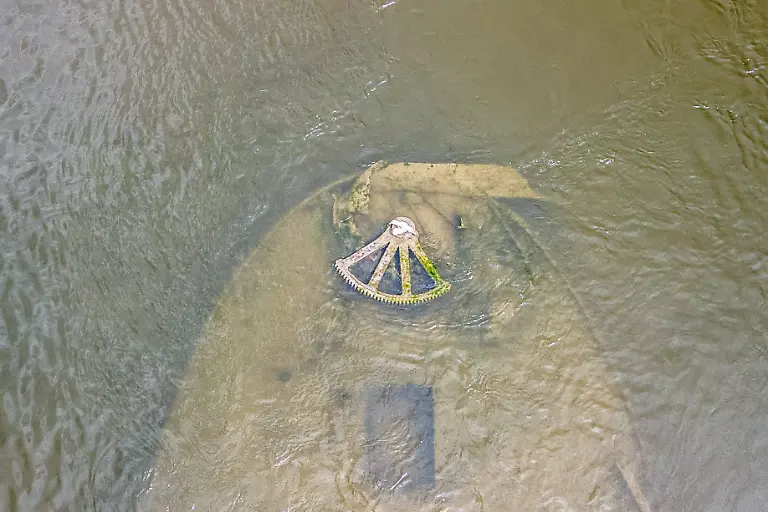 Low-water-reveals-remains-of-century-old-ship-on-Croatia-s-Danube-An-aerial-view-shows-the-remains-of-a-ship-believed-to-be-more-than-a-century-old-after-record-low-water-levels-in-the-Danube-River-exposed-the-wreck-in-Opatovac-Croatia-on-July-21-2026-The-vessel-is-believed-to-have-sunk-between-the-two-World-Wars