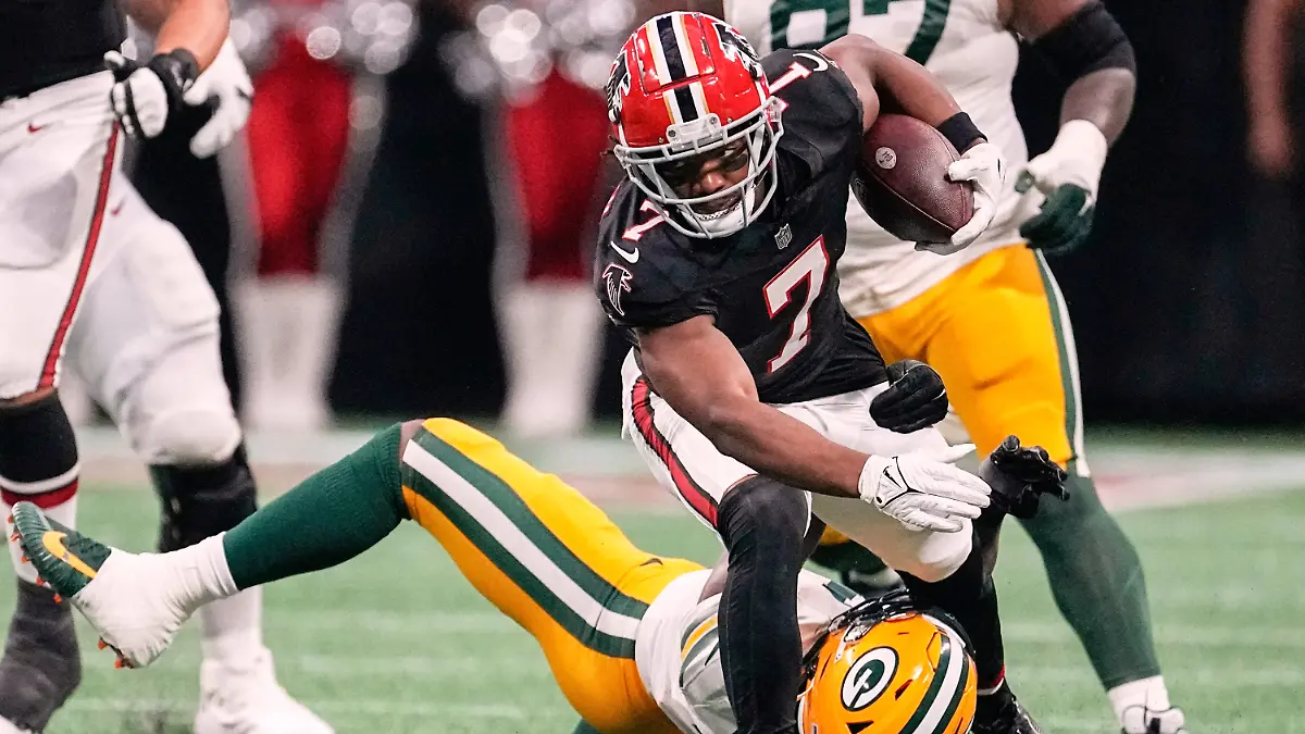 FILE-Atlanta-Falcons-running-back-Bijan-Robinson-top-front-runs-over-Green-Bay-Packers-linebacker-Quay-Walker-bottom-during-the-first-half-of-an-NFL-football-game-Sept-17-2023-in-Atlanta