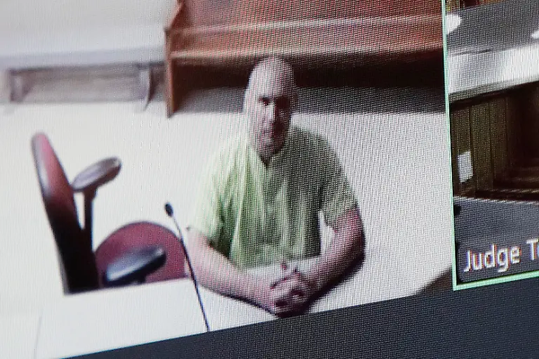 Arson-suspect-Aaron-Farinacci-waits-for-his-initial-court-appearance-by-video-at-the-county-courthouse-in-Spokane-Wash-Tuesday-Aug