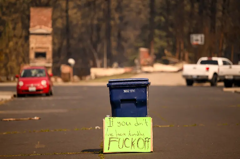 A-sign-wards-off-outsiders-during-the-Old-Trails-fire-in-Spokane-Washington-on-August-4-2026-US-authorities-arrested-a-man-on-August-3-2026-on-suspicion-of-arson-in-connection-with-the-biggest-of-three-fires-burning-around-the-northwestern-city-of-Spokane-as-firefighters-raced-to-contain-flames-that-have-displaced-tens-of-thousands-Wildfires-supercharged-by-drought-and-intense-heat-have-torn-through-the-city-in-Washington-state-burning-thousands-of-acres-and-reducing-hundreds-of-buildings-to-cinders-while-anxious-families-await-news-on-when-they-can-return
