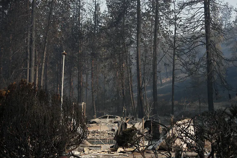 A-vehicle-and-structure-are-burned-near-a-hillside-after-a-wildfire-in-the-Indian-trail-neighborhood-Monday-Aug-3-2026-in-Spokane-Wash