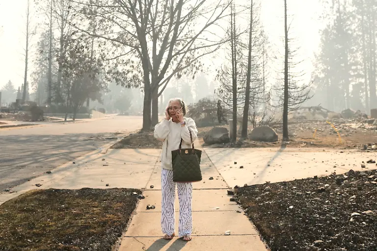 Miriam-Sim-76-reacts-as-she-walks-through-the-burned-remains-of-her-neighborhood-after-a-wildfire-hit-the-northern-part-of-Spokane-Wash-Monday-Aug-3-2026