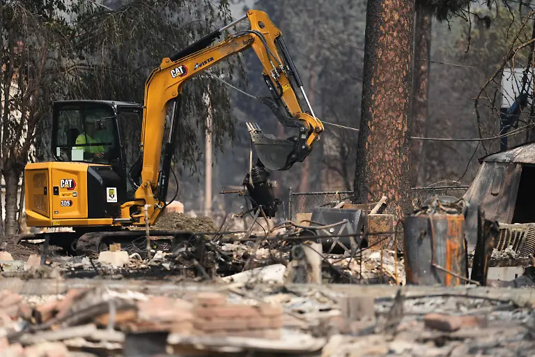 Crews-work-near-several-burned-down-houses-after-a-wildfire-hit-the-northwest-part-of-Spokane-Wash-Tuesday-Aug-4-2026