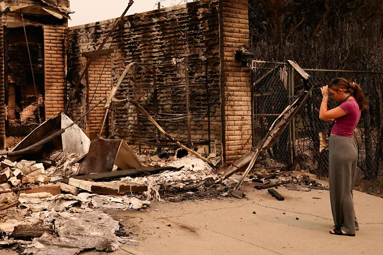 Ash-Sollie-looks-at-her-grandparents-home-where-she-previously-lived-after-it-was-destroyed-by-a-wildfire-in-Spokane-Washington-U-S-August-2-2026