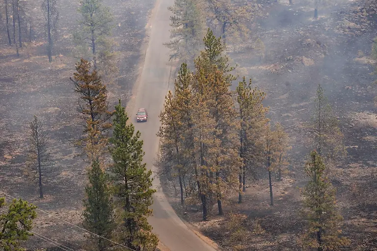 A-vehicle-drives-by-as-smoke-billows-from-the-Old-Trails-Fire-as-wildfires-burn-in-Spokane-Washington-U-S-August-2-2026