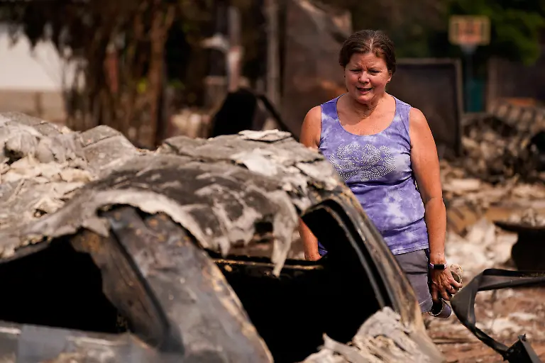 Nancy-Fuller-ispects-a-remains-of-her-burned-home-in-the-Old-Trails-Fire-in-Spokane-Washington-U-S-August-3-2026