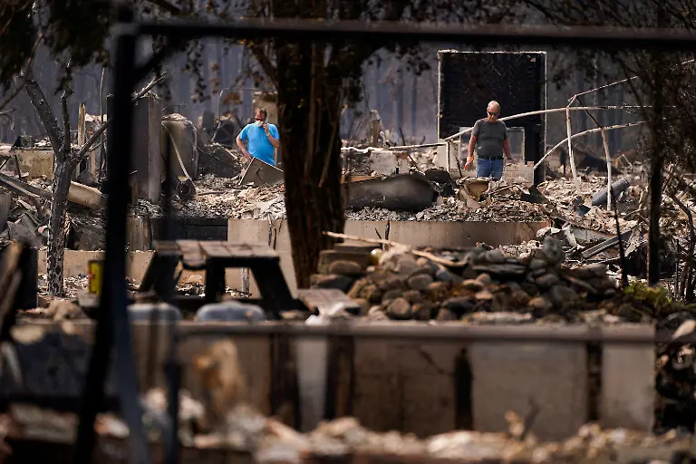 Tim-Hansen-and-Scott-Fuller-inspect-the-remains-of-a-burned-home-owned-by-the-Fuller-family-in-the-Old-Trails-Fire-in-Spokane-Washington-U-S-August-3-2026